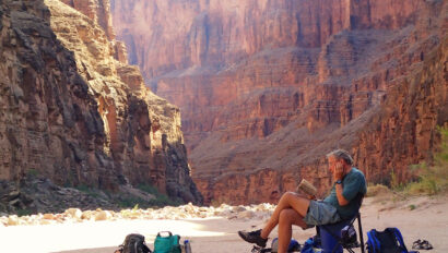 A man reading a book in Grand Canyon